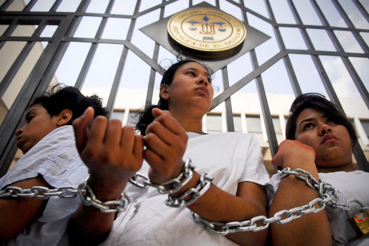Women stand chained together outside the Supreme Court during a protest in San Salvador May 15, 2013.          (Reuters/Ulises Rodriguez)