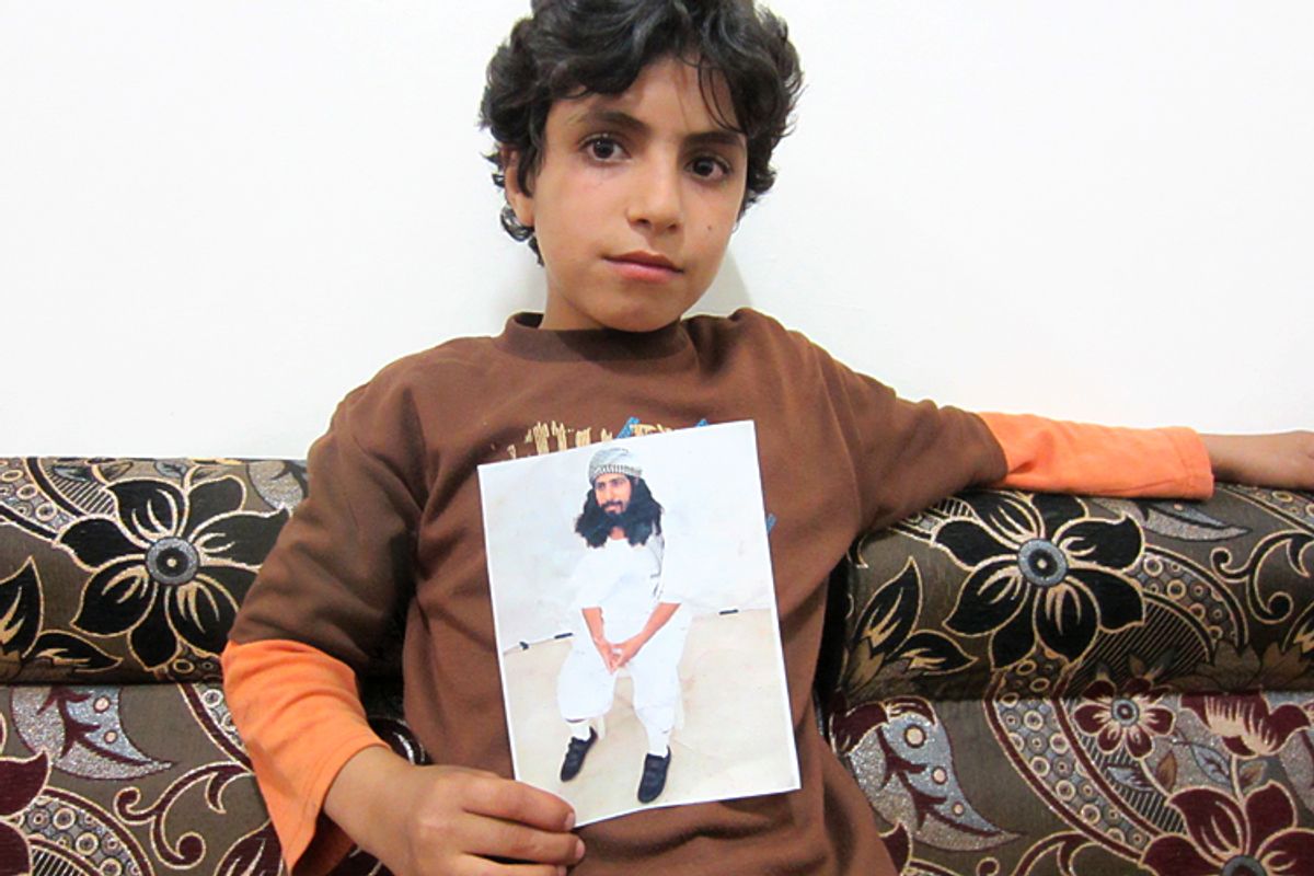 Muhammad al-Baidhani holds a photo of his father, Abdul Khaliq al-Bhaidani, who is held at Guantanamo without charge. (C) Letta Tayler, Human Rights  