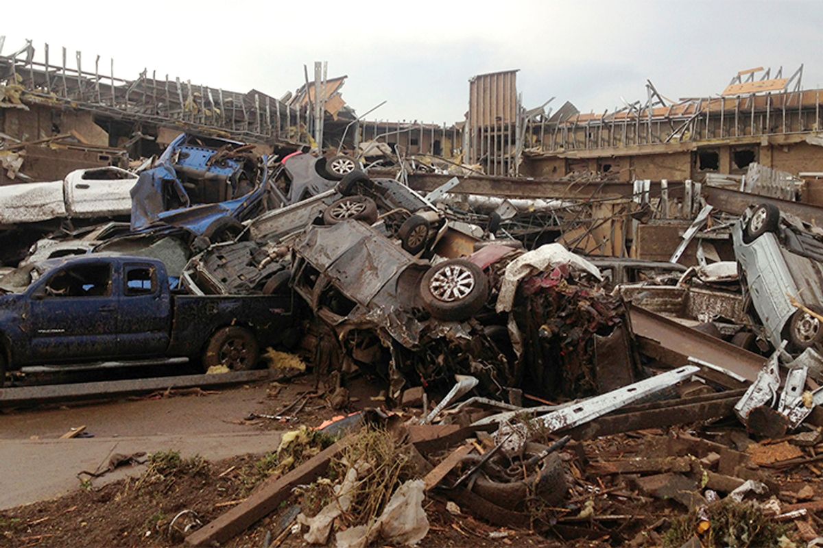 Overturned cars are seen after a huge tornado touched down in the town of Moore, near Oklahoma City, Oklahoma May 20, 2013.           (Reuters)