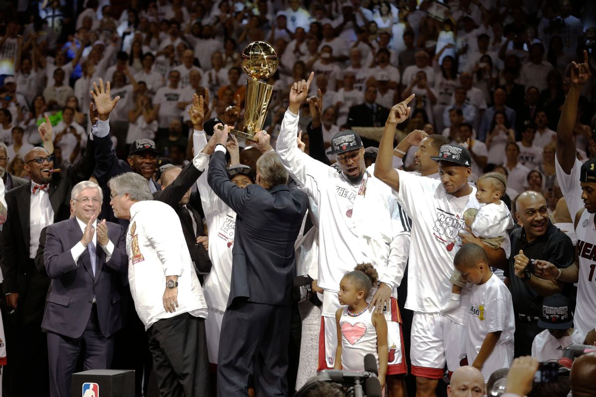 The Miami Heat celebrate after defeating the San Antonio Spurs 95-88 to win their second straight NBA championship.   (AP/Lynne Sladky)