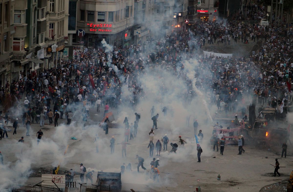 Police throw tear gas at protesters during clashes at the Taksim Square in Istanbul Tuesday, June 11, 2013.     (AP/Thanassis Stavrakis)