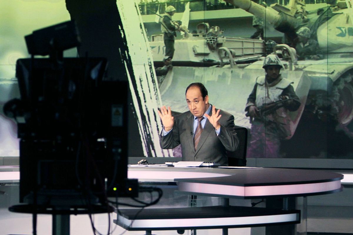Announcer Abdul Samad Nasser, in the studio of the Arabic Al Jazeera satellite news channel.   (Reuters/Fadi Al-assaad)