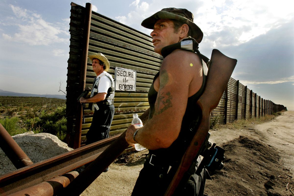 California Minutemen volunteers look over the Border wall for immigrants trying to cross into the United States in Campo, California.  (AP/Sandy Huffaker)