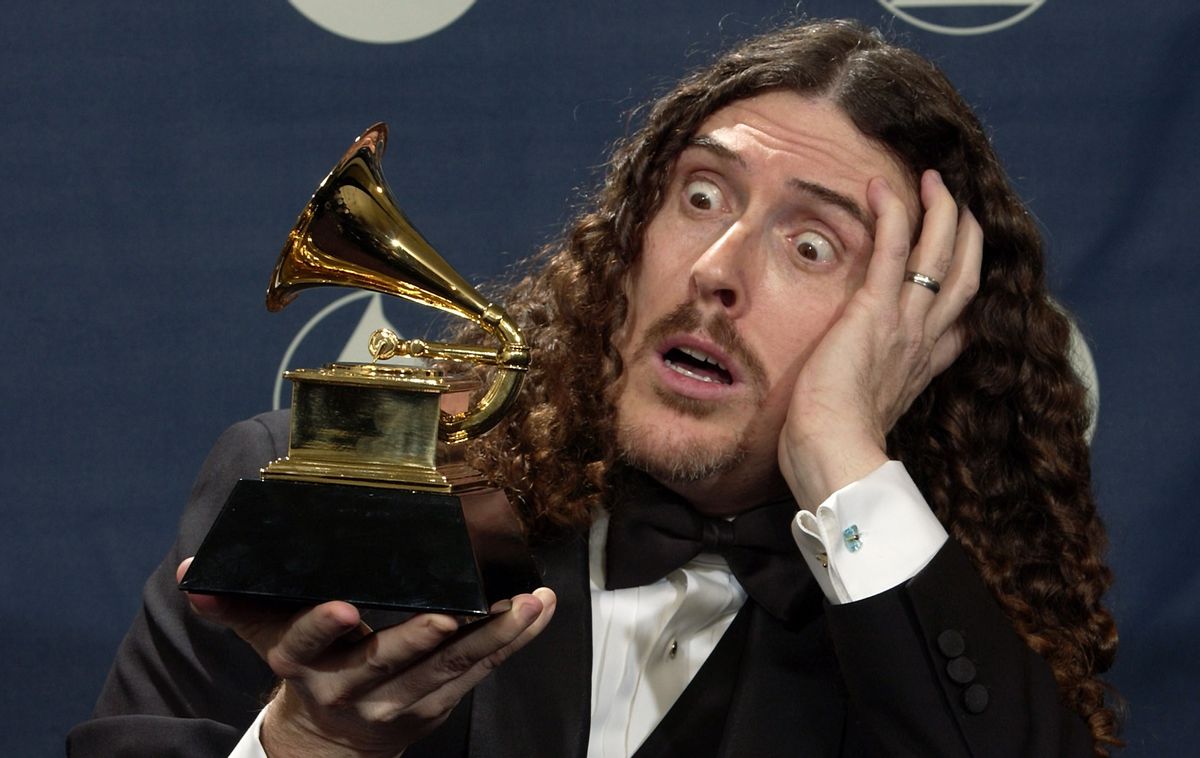 "Weird Al" Yankovic clowns around with the award he won for best comedy album for "Poodle Hat" at the 46th Annual Grammy Awards, Sunday, Feb. 8, 2004, in Los Angeles. (AP Photo/Reed Saxon)  (AP/Reed Saxon)