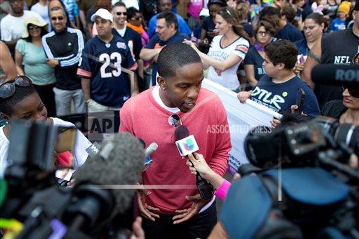 Former NFL football player Wade Davis speaks to reporters prior to the Chicago Gay Pride Parade, Sunday, June 30, 2013.      (AP Photo/Scott Eisen)