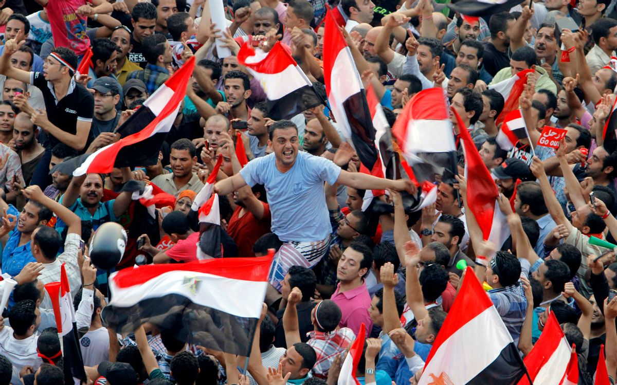Opponents of Egypt's Islamist President Mohammed Morsi shout slogans and wave a national flags in Tahrir Square in Cairo, Egypt, Wednesday, July 3, 2013.  (AP/Amr Nabil)