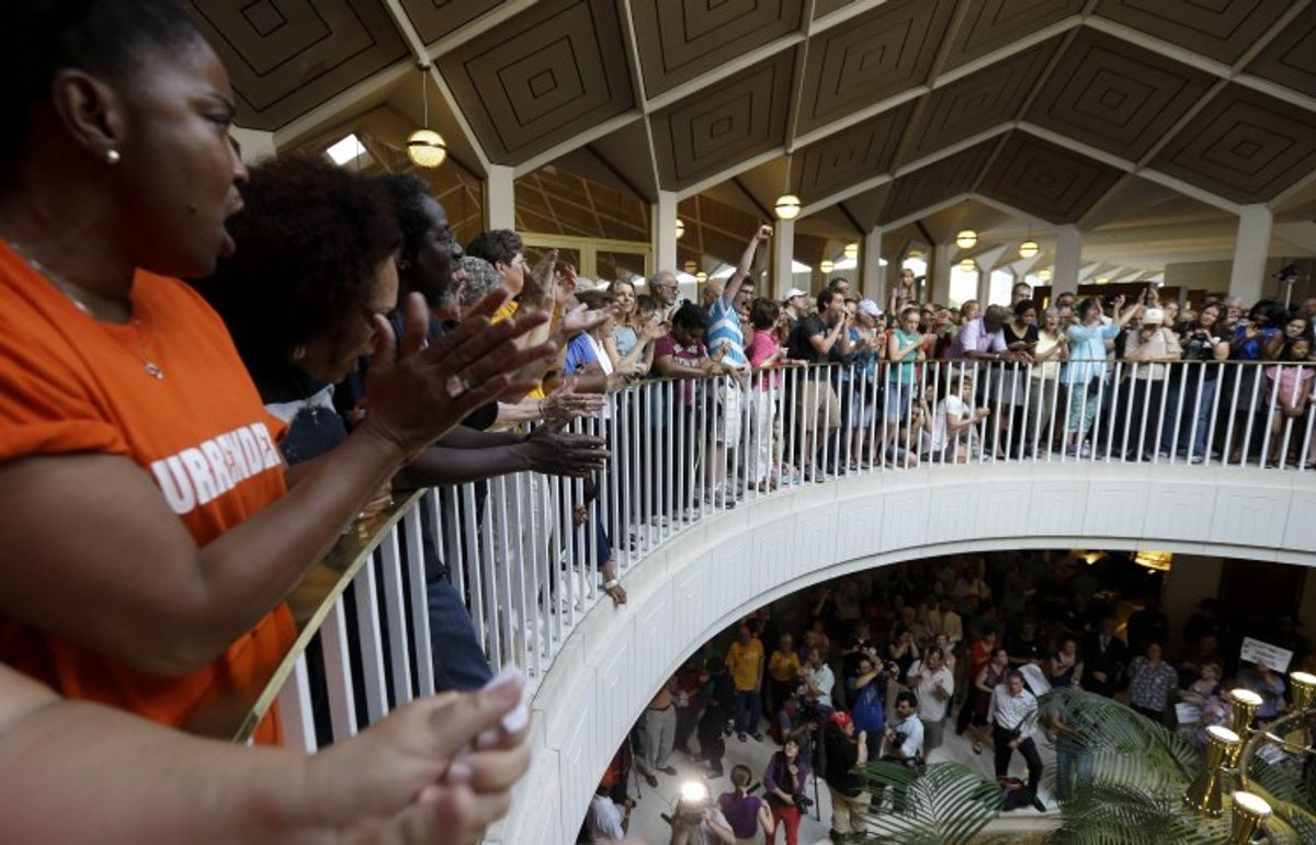 Protestors gather around the balcony overlooking the House and Senate floors during a demonstration at the state legislature in Raleigh, N.C., Monday, June 17, 2013. (AP)
