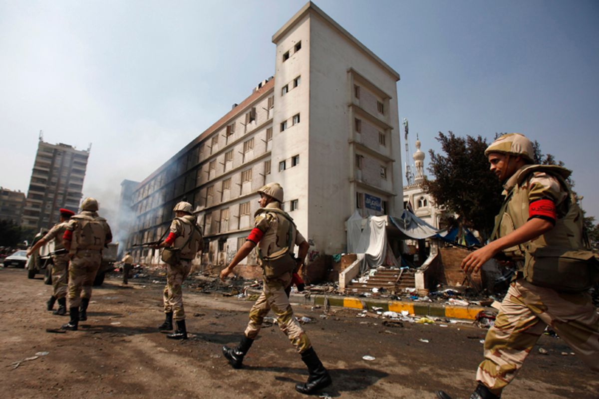 Egyptian soldiers move near a burnt annex building of Rabaa Adawiya mosque in Cairo, August 15, 2013.  (Reuters/Amr Dalsh)