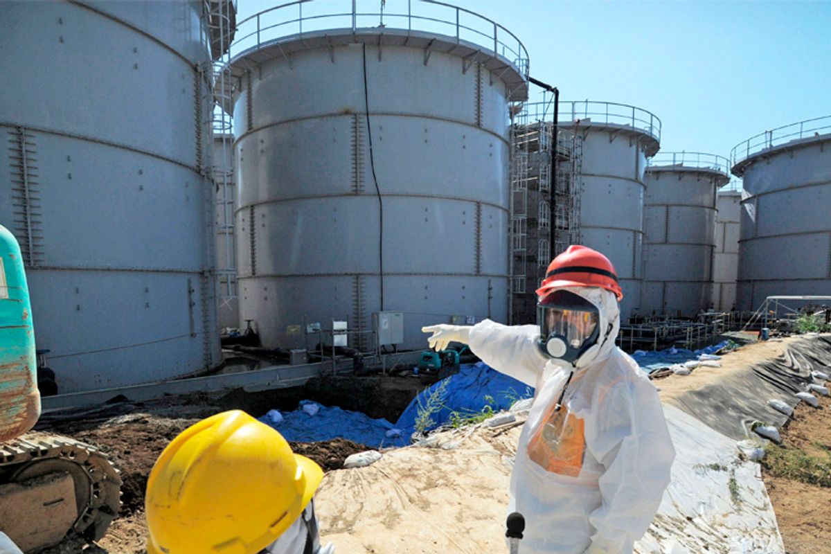 Japan's Economy, Trade and Industry Minister Toshimitsu Motegi (R), inspects contaminated water tanks          (Reuters/Kyodo Kyodo)
