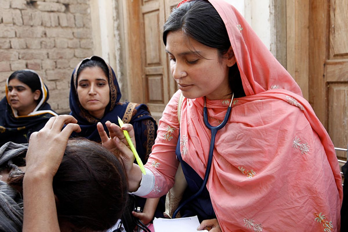 A female doctor with the International Medical Corps examines a woman patient at a mobile health clinic in Pakistan    (Wikimedia Commons)