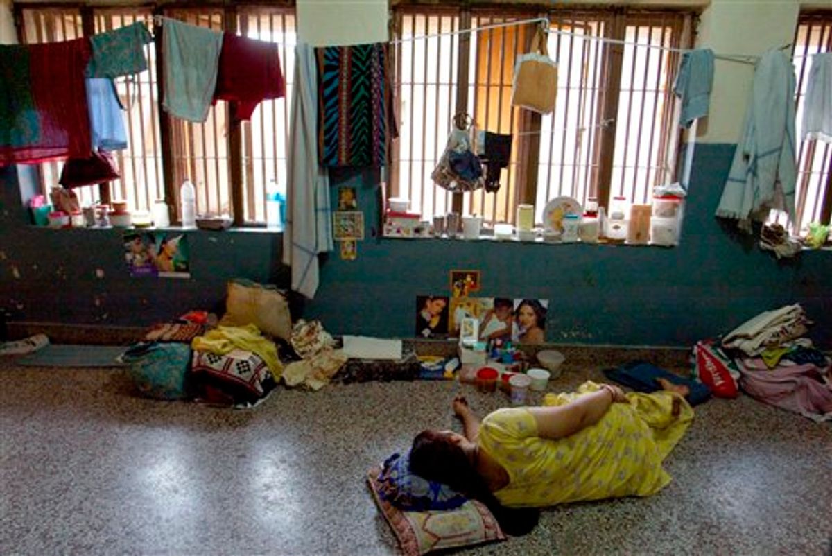 An in-law accused of dowry crimes sleep at a communal cell in Tihar Jail's dowry wing, in Asia's largest prison in New Delhi, India. An Indian report released in August 2013, says a woman dies every hour in disputes over how much her family has paid in dowry to the groom for her marriage.   (AP)