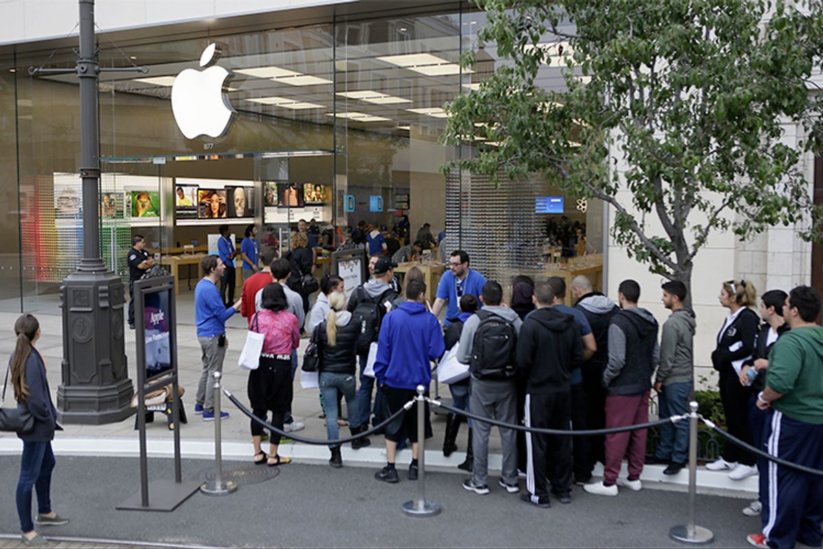 Customers wait in line to buy the latest versions of the iPhone during the opening day of sales of the iPhone 5s and iPhone 5C at the Apple store in Glendale, Calif., Sept. 20, 2013.          (AP/Damian Dovarganes)