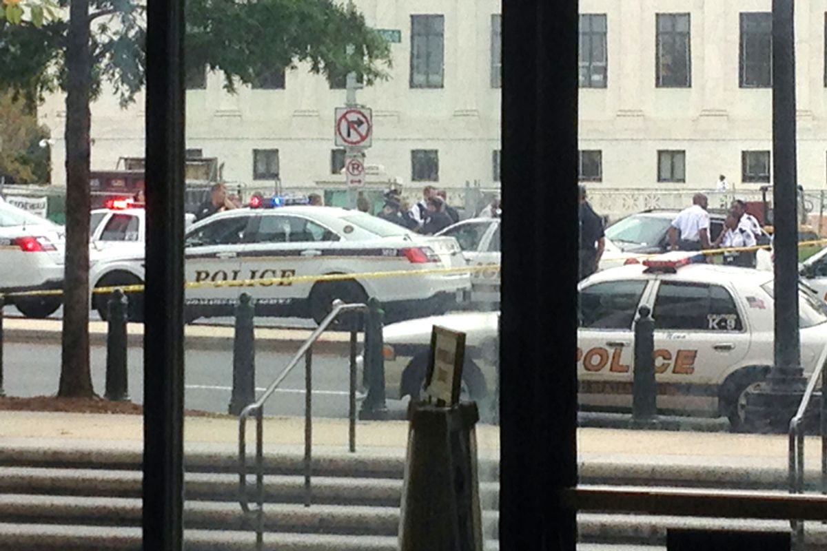 Law enforcement vehicles converge on the scene of a shooting on Constitution Avenue outside the Hart U.S. Senate Office Building as seen from inside the lobby of the building on Capitol Hill in Washington, October 3, 2013           (Reuters)