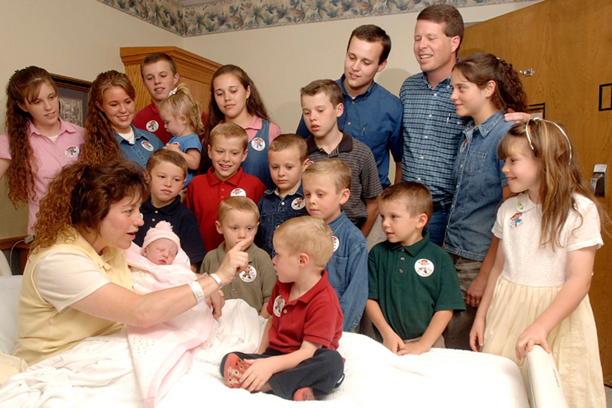 In this Aug. 2, 2007 photo, Michelle Duggar is surrounded by her then only 17 children, and husband Jim Bob.                             (AP/Beth Hall)