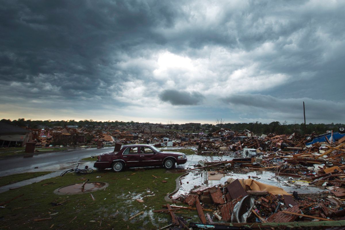 The clouds of a thunderstorm roll over neighborhoods heavily damaged in a tornado in Moore, Okla., May 23, 2013.      (Reuters/Lucas Jackson)