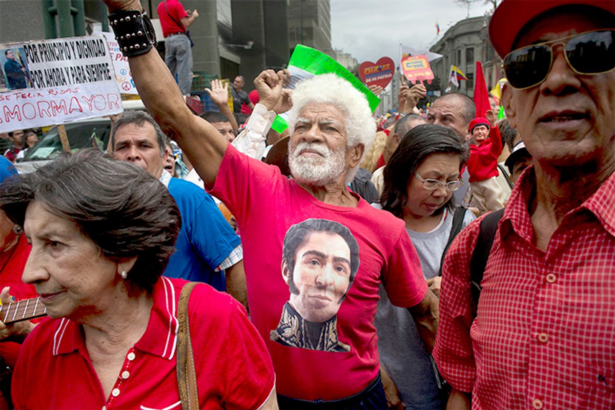 A man wearing a T-shirt of Venezuela's independence hero Simon Bolivar chants pro-government slogans during a march by elderly people in Caracas, Venezuela, Feb. 23, 2014.      (AP/Rodrigo Abd)