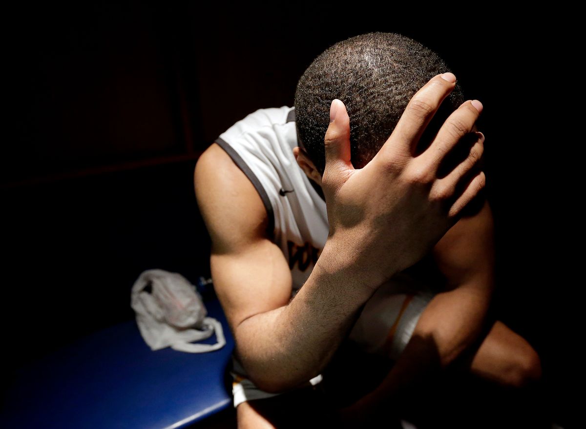 10ThingstoSeeSports - Wichita State's Tekele Cotton sits in the locker room after losing their third-round game against Kentucky at the NCAA college basketball tournament Sunday, March 23, 2014, in St. Louis. Kentucky won the game 78-76. (AP Photo/Charlie Riedel, File) (AP)