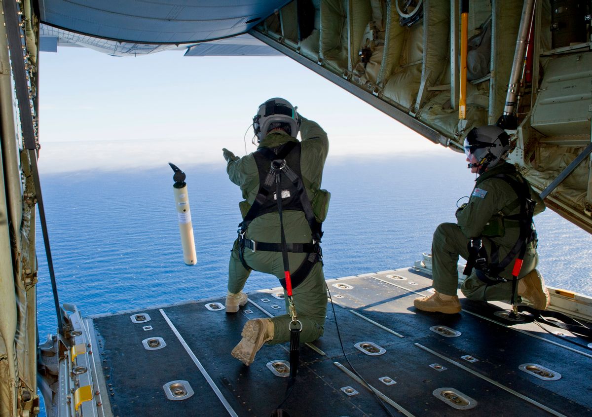 FILE - In this March 20, 2014 file photo provided by the Australia Defence Department, Royal Australian Air Force Loadmasters Sgt. Adam Roberts, left, and Flight Sgt. John Mancey, launch a Self Locating Data Marker Buoy from a C-130J Hercules aircraft in the southern Indian Ocean as part of the Australian Defence Force's assistance to the search for Malaysia Airlines flight MH370. The disappearance of the airplane has presented two tales of modern technology. The public has been surprised to learn of the limitations of tracking and communications devices, which contributed to the plane vanishing for more than two weeks. But the advanced capabilities of some technologies, particularly satellites, have provided hope that the mystery won't go unsolved. (AP Photo/Australian Defence Department, Justin Brown, File) (AP)