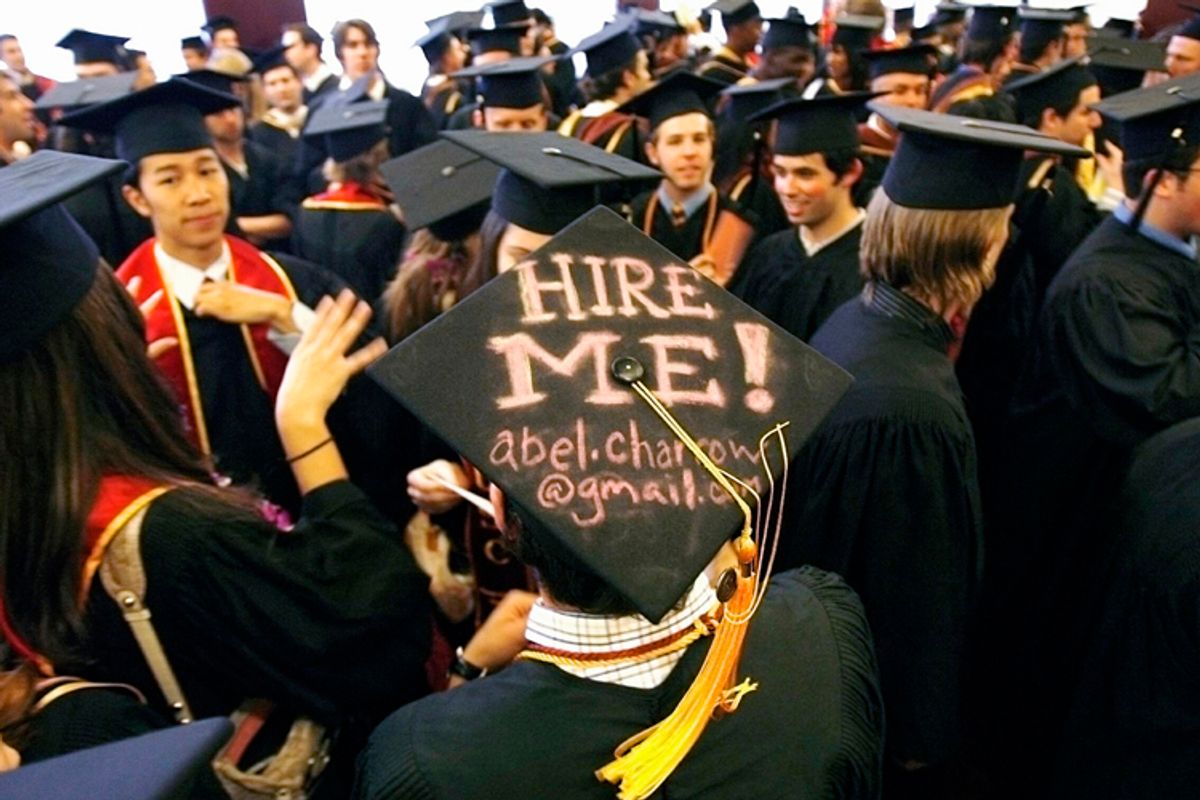 Graduating student Abel Charron displays a "Hire me" sign written on his mortar board before commencement at the University of Southern California, May 11, 2007.     (Reuters/Mario Anzuoni)