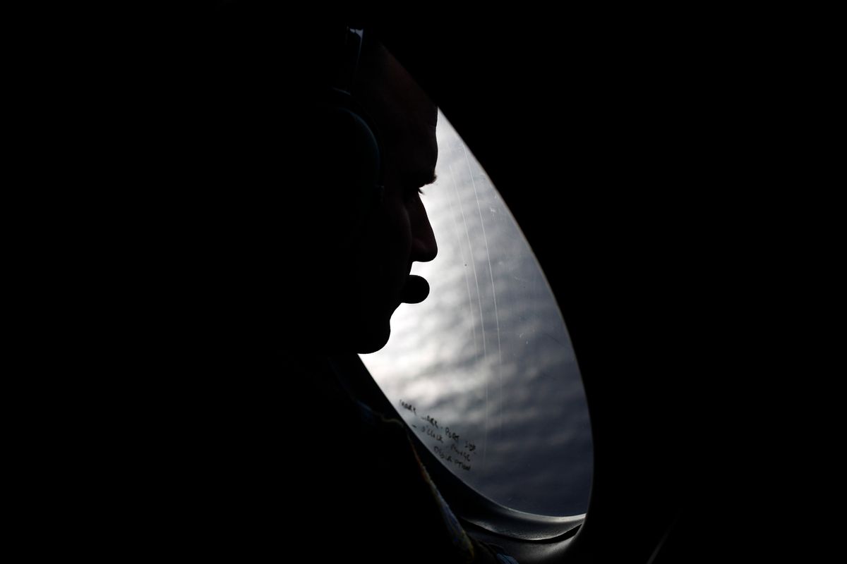 A Royal New Zealand Air Force crew member looks into the southern Indian Ocean from a P-3K2 Orion aircraft searches for missing Malaysian Airlines flight 370, Saturday, March 29, 2014. A day after the search for the Malaysian jetliner shifted to a new area of the Indian Ocean, ships on Saturday plucked objects from the sea to determine whether they were related to the missing jet. None were confirmed to be from the plane, leaving searchers with no sign of the jet three weeks after it disappeared. (AP Photo/Jason Reed, Pool)  (AP)