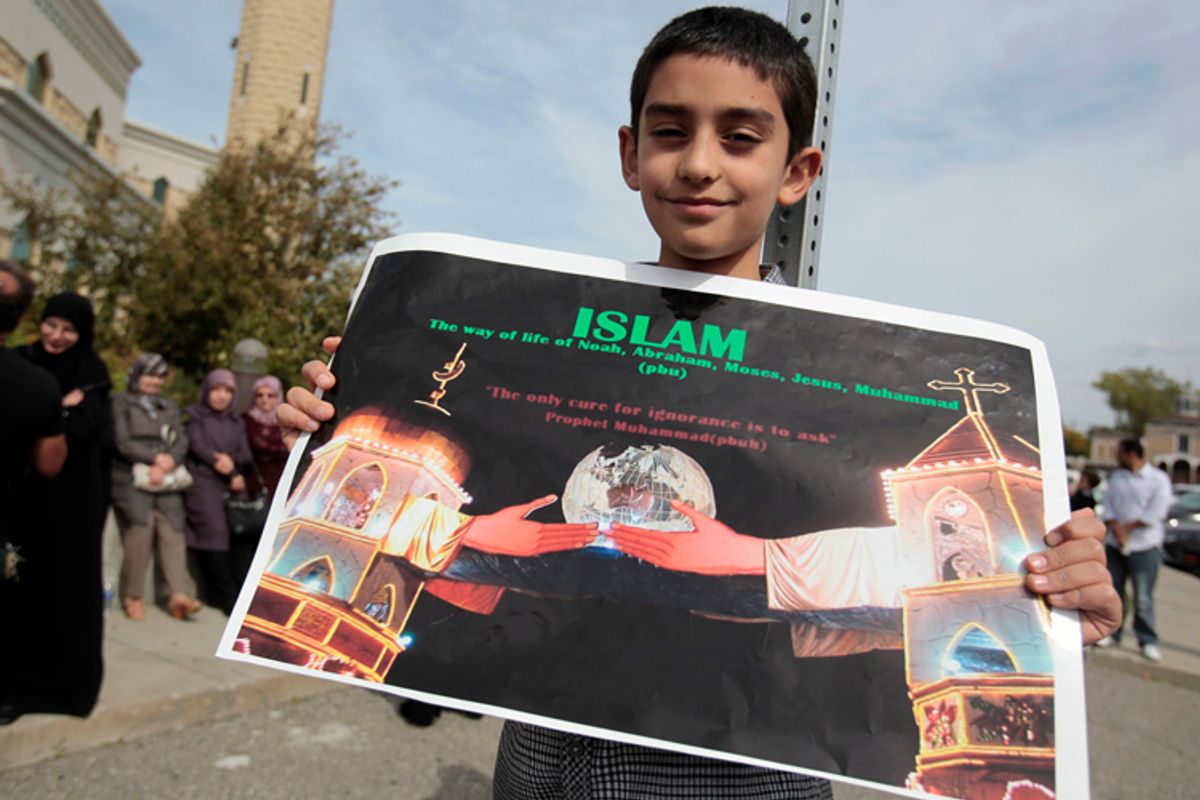 Muslim-American Ali-Jaafar Al-Zain, 9, holds a poster during a peaceful interfaith rally in Dearborn, Michigan September 21, 2012.       (Reuters/Rebecca Cook)