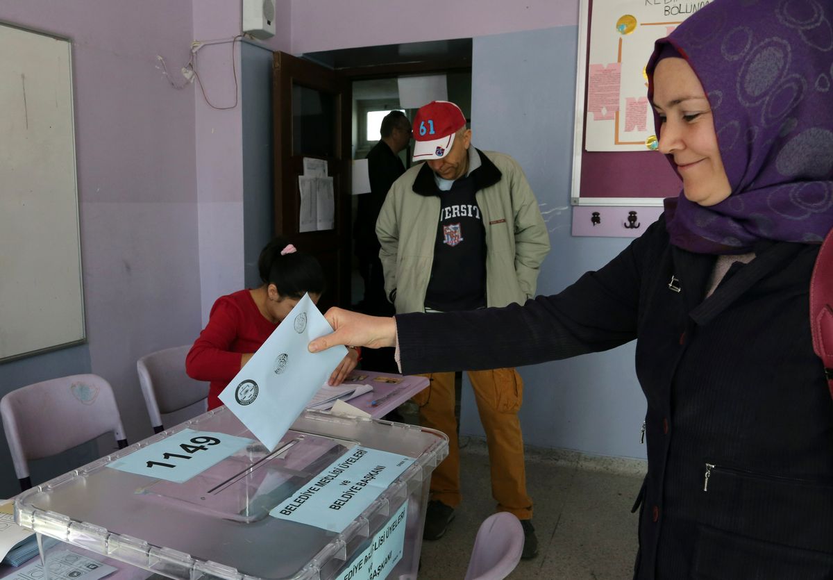 A Turkish woman casts her ballot at a polling station in Ankara Turkey, Sunday,  (Burhan Ozbilici)