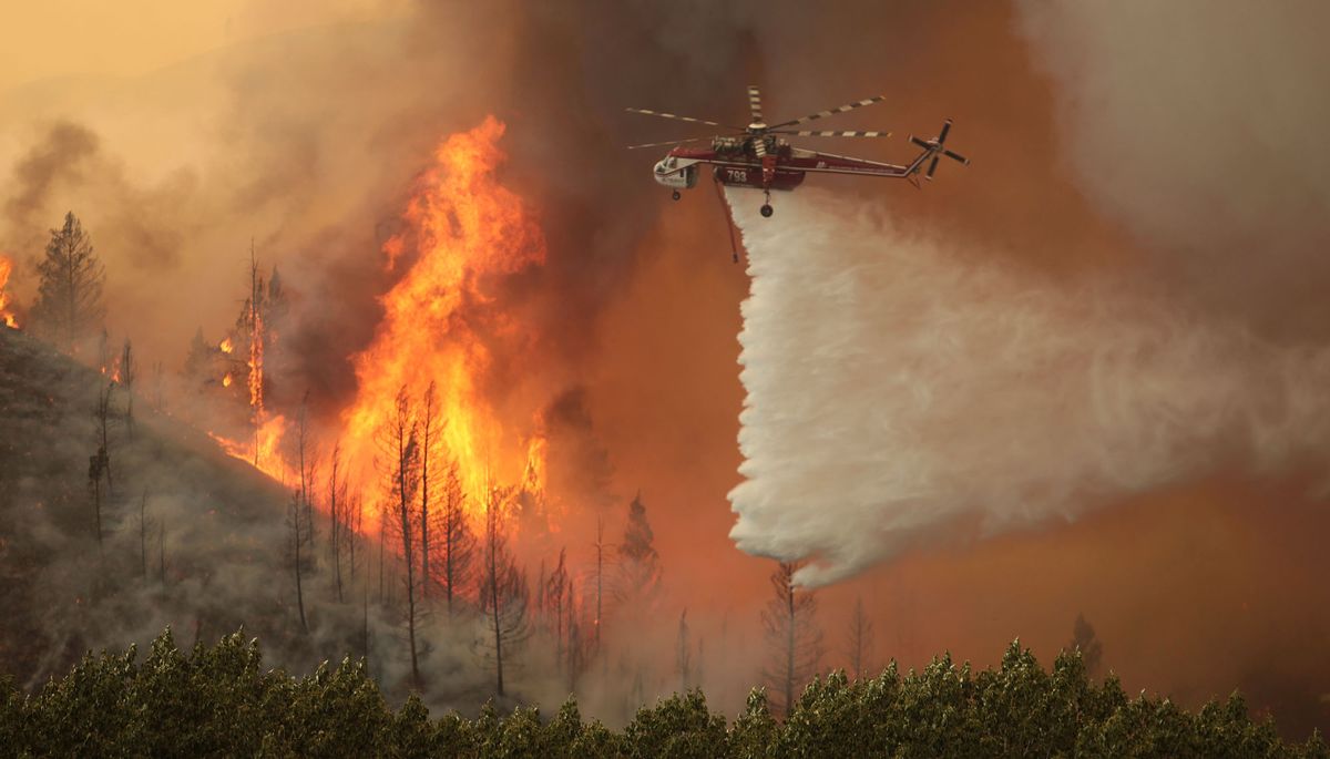 This Aug. 16, 2013 file photo shows helicopters battling the 64,000 acre Beaver Creek Fire north of Hailey, Idaho. (AP Photo/Times-News, Ashley Smith, File) 