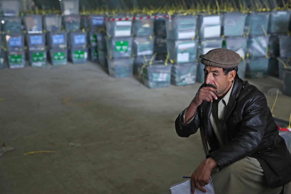 An Afghan election worker rests while working with ballot boxes at a warehouse of the Independent Elections Commission warehouse in Kabul, Afghanistan, Sunday, April 6, 2014. Trucks and donkeys loaded with ballot boxes made their way to counting centers on Sunday as Afghans and the international community sighed with relief that national elections were held without major violence despite a Taliban threat. (AP Photo/Massoud Hossaini) (AP)