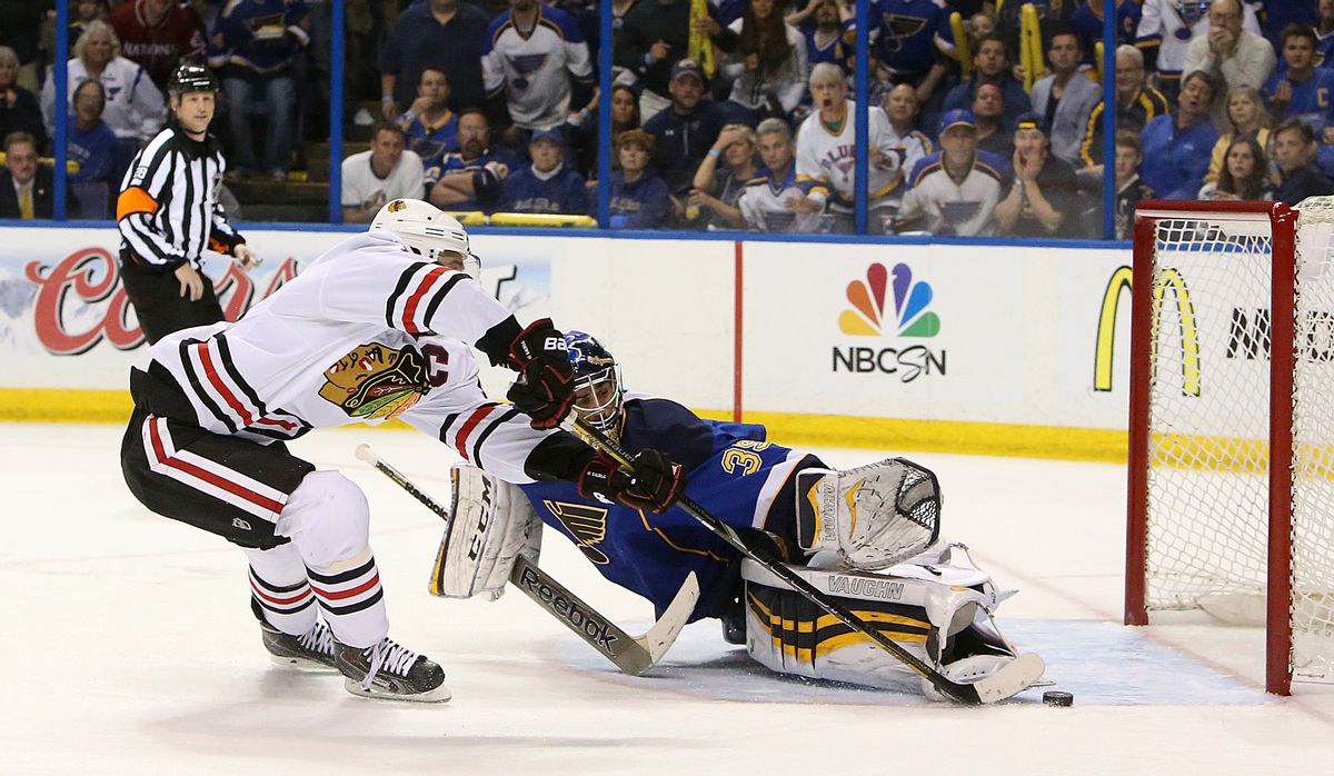 Chicago Blackhawks center Jonathan Toews (left) scores the game-winning goal in overtime past St. Louis Blues goaltender Ryan Miller during Game 5 of a Western Conference quarterfinal playoff game Friday, April 25, 2014, at the Scottrade Center in St. Louis. (AP Photo/The St. Louis Post-Dispatch, Chris Lee) (AP)