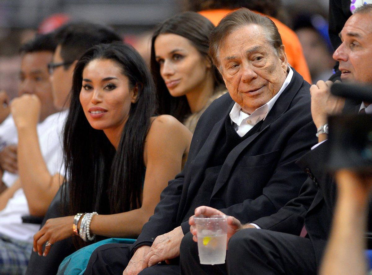 In this photo taken on Friday, Oct. 25, 2013, Los Angeles Clippers owner Donald Sterling, right, and V. Stiviano, left, watch the Clippers play the Sacramento Kings during the first half of an NBA basketball game in Los Angeles. The NBA is investigating a report of an audio recording in which a man purported to be Sterling makes racist remarks while speaking to Stiviano.  NBA spokesman Mike Bass said in a statement Saturday, April 26, 2014, that the league is in the process of authenticating the validity of the recording posted on TMZ's website. Bass called the comments "disturbing and offensive."  (AP Photo/Mark J. Terrill)             (AP)