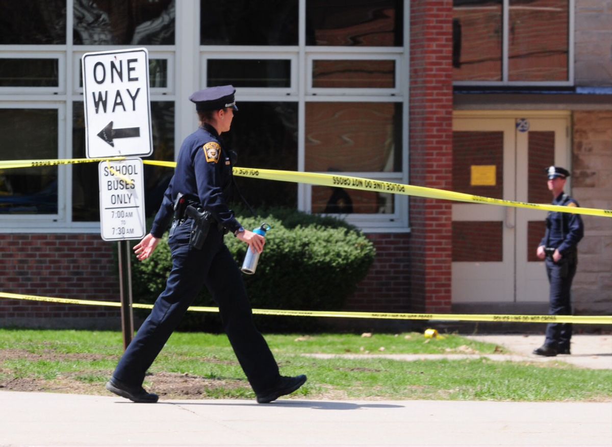Police remain on scene at Jonathan Law High School where a 16-year-old girl was stabbed to death in Milford, Conn., Friday, April 25, 2014. A teenage boy is in custody, and police are investigating whether the attack stemmed from her turning down an invitation to be his prom date. (AP Photo/The New Haven Register, Peter Hvizdak) MANDATORY CREDIT (AP)