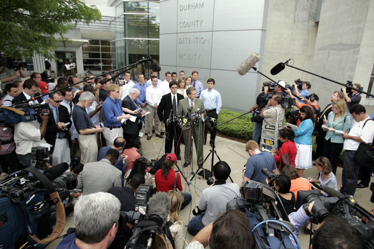 Joe Cheshire, attorney, at podium, and David Evans, senior captain of the Duke lacrosse team, right, make a statement in front of the Durham County Detention Center, May 15, 2006.   (AP/Gerry Broome)