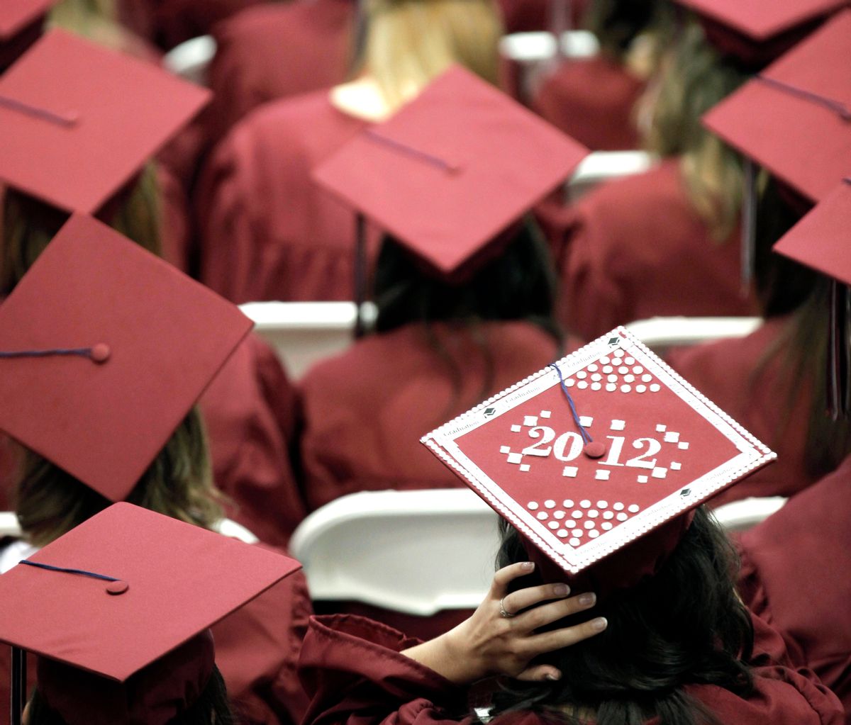 FILE - In this May 21, 2012, file photo, graduates from Joplin High School listen to speakers during commencement ceremonies in Joplin, Mo. U.S. public high schools have reached a milestone, an 80 percent graduation rate. Yet that still means 1 of every 5 students walks away without a diploma. Citing the progress, researchers are projecting a 90 percent national graduation rate by 2020.  (AP Photo/Charlie Riedel, File)
