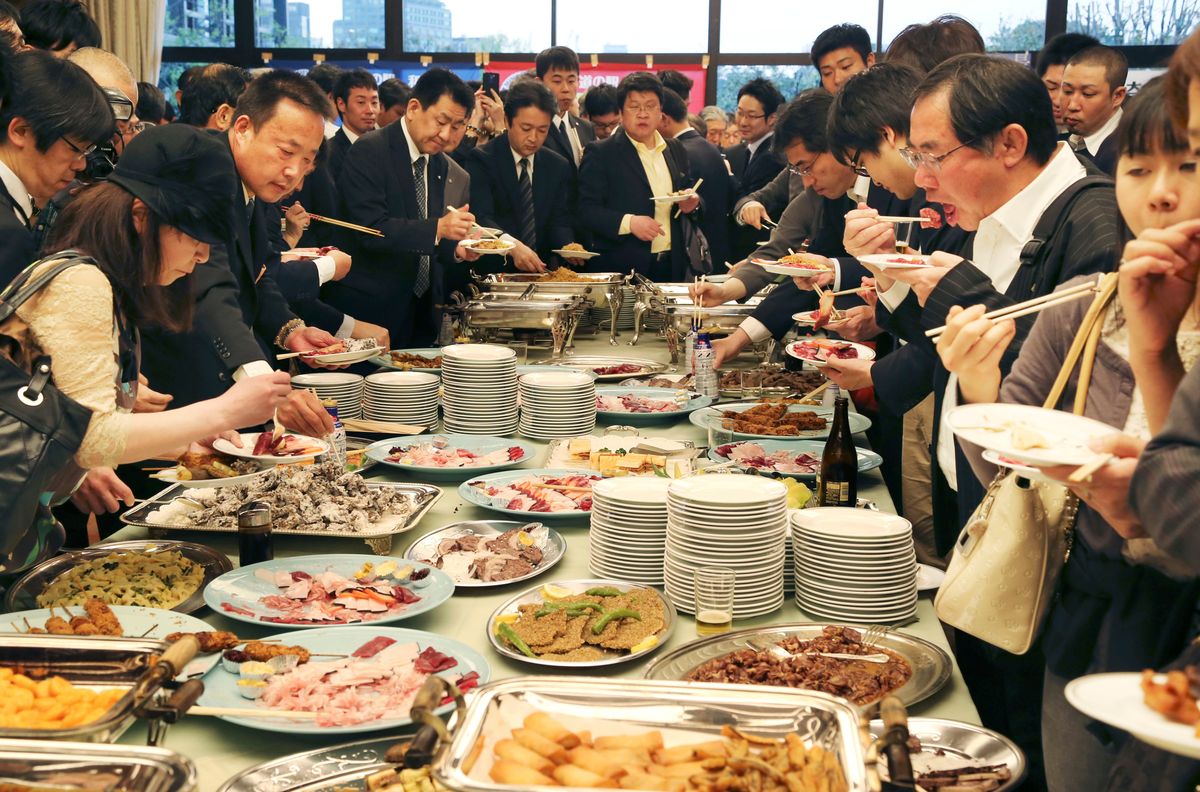 Supporters of whaling eat meat of whale during a meeting of the 26th support whaling event in Tokyo, Tuesday, April 15, 2014. (AP Photo/Koji Sasahara)  (Koji Sasahara)