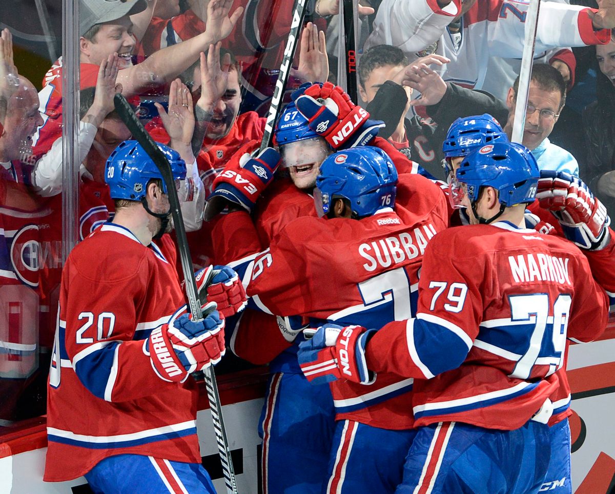 Montreal Canadiens left wing Max Pacioretty (67) is mobbed by teammates after scoring the winning goal against the Tampa Bay Lightning during third period National Hockey League Stanley Cup playoff action on Tuesday, April 22, 2014 in Montreal. (AP Photo/The Canadian Press, Ryan Remiorz) (AP)