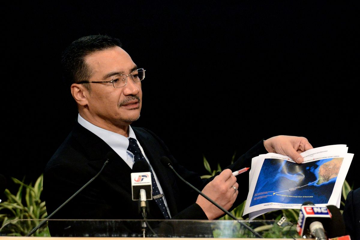Malaysia's Defense Minister and acting Transport Minister Hishammuddin Hussein shows a printout of the latest satellite image of objects that might be from the missing Malaysia Airlines plane, at Putra World Trade Center in Kuala Lumpur, Malaysia, Wednesday, March 26, 2014. Hishammuddin said the objects were seen close to where three other satellites previously detected objects.  (AP Photo/Joshua Paul)   (Joshua Paul)