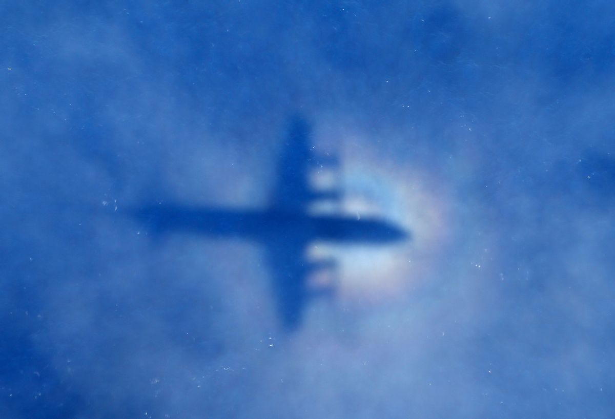 In this March 31, 2014 photo, a shadow of a Royal New Zealand Air Force P-3 Orion aircraft is seen on low cloud cover while it searches for missing Malaysia Airlines Flight MH370 in the southern Indian Ocean.  ((AP Photo/Rob Griffith))