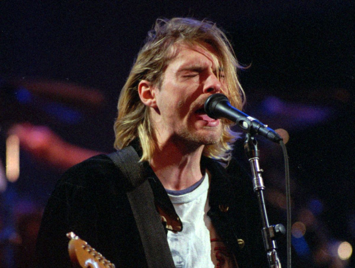 This Dec. 13, 1993 file photo shows Kurt Cobain of the Seattle band Nirvana performing in Seattle, Wash. Nirvana, which changed music and fashion in the 1990s with the punk rock-inspired grunge sound, is joining the Rock and Roll Hall of Fame in a class with Kiss, Peter Gabriel and Hall & Oates. Nirvana is being inducted in its first year of eligibility. The trio's "Smells Like Teen Spirit" hit like a thunderclap upon its 1991 release, briefly making the Pacific Northwest rock's hottest scene before the band ended abruptly with singer Kurt Cobain's suicide in 1994.  (AP Photo/Robert Sorbo)