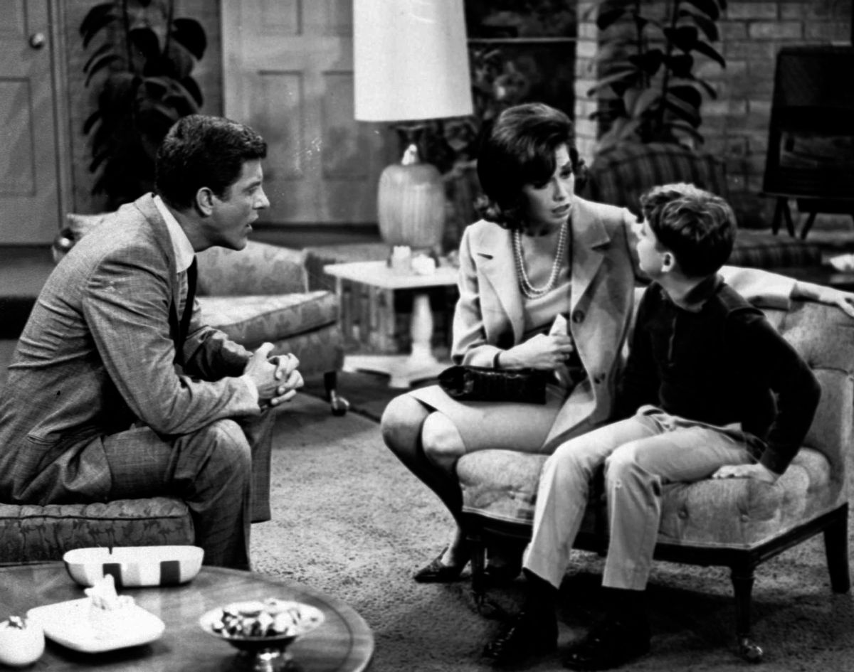 FILE - In this 1965 file photo, from left, Dick Van Dyke, as Rob Petrie, and Mary Tyler Moore, as Laura Petrie, talk to Larry Matthews, who plays their son, Ritchie, on "The Dick Van Dyke Show." Moore is being spotlighted in a new DVD collection called "The Dick Van Dyke Show: Classic Mary Tyler Moore Episodes." The set gathers 20 episodes that dwell on the home life of Rob and Laura Petrie, putting the comic radiance of Moore on full display. (AP Photo/File) (AP)