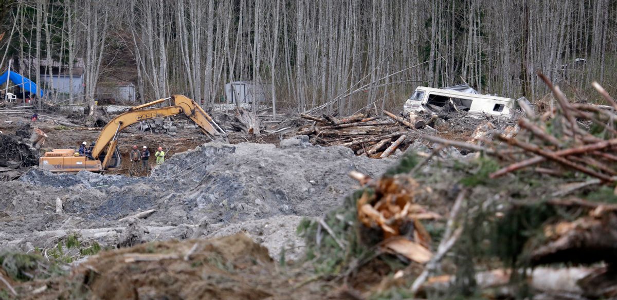 A demolished recreational vehicle lies in a debris field at the scene of a deadly mudslide nearly two weeks earlier nearby, Thursday, April 3, 2014, in Oso, Wash. (AP Photo/Elaine Thompson)  