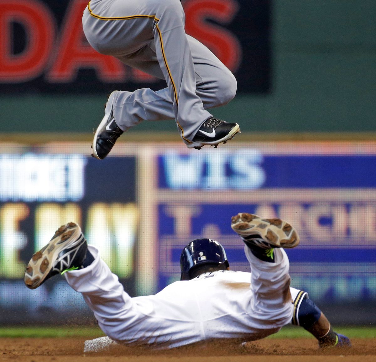 10ThingstoSeeSports - Pittsburgh Pirates shortstop Jordy Mercer can't handle a high throw as he leaps over Milwaukee Brewers' Jean Segura stealing second during the third inning of a baseball game Thursday, May 15, 2014, in Milwaukee. (AP Photo/Morry Gash, File) (AP)