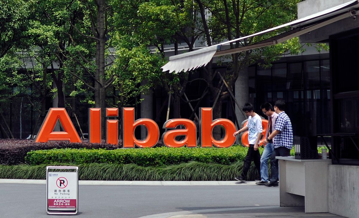 In this May 21, 2012 file photo, men walk past the corporate logo at the headquarters compound of Alibaba Group in Hangzhou in eastern China's Zhejiang province. Alibaba Group is aiming to raise $1 billion in a long-awaited IPO likely to have ripple effects across the Internet.   ((AP Photo/File))