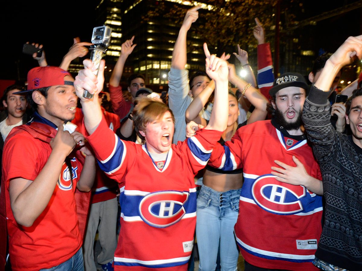 Montreal Canadiens fans celebrate their team's third goal against the Boston Bruins, as they watch the broadcast of the game on a large TV screen in Montreal on Wednesday, May 14, 2014. (AP Photo/The Canadian Press, Ryan Remiorz) (AP)