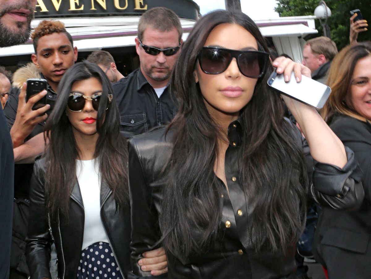 Kim Kardashian, front and Kourtney Kardashian, left, leave at a restaurant in Paris, Thursday, May 22, 2014. (AP Photo/Jacques Brinon)  