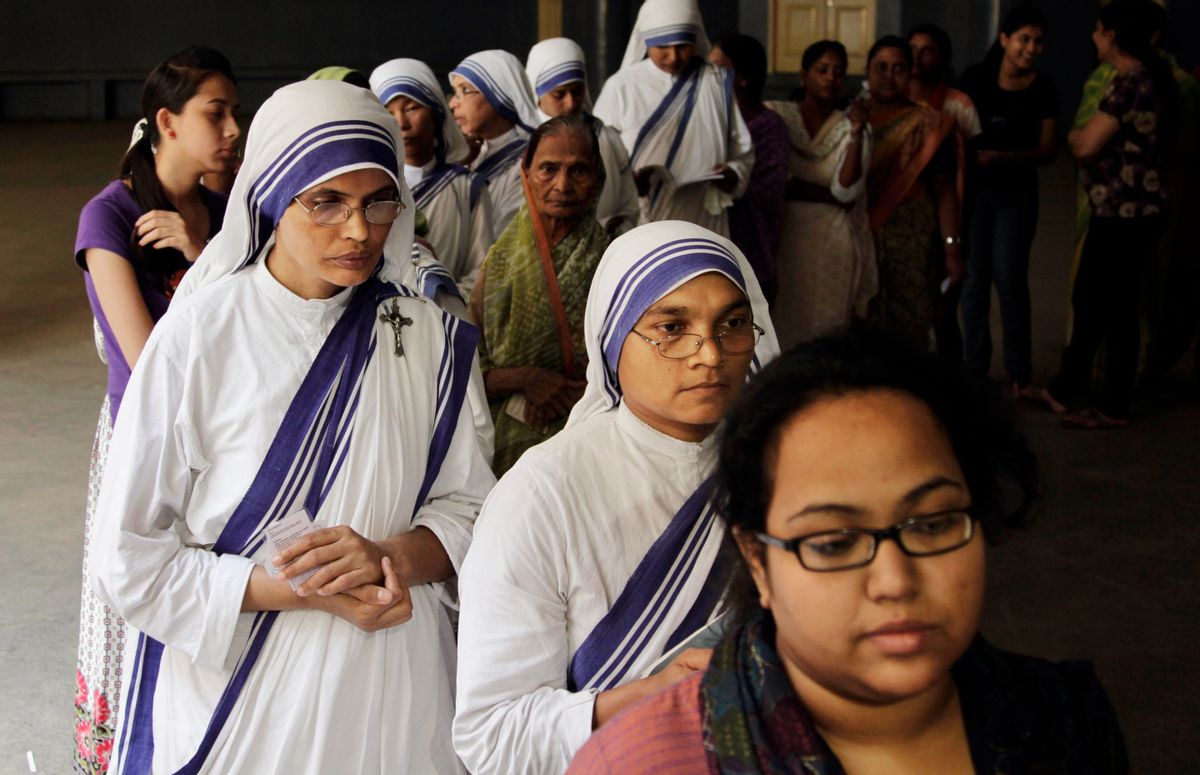 Nuns of the Missionaries of Charity, the order founded by Mother Teresa, stand in a queue to cast their votes on the final day of polling in Kolkata, India, Monday, May 12, 2014. Millions of Indian voters wrapped up a mammoth national election Monday, braving the searing sun on the final day of polling with the Hindu nationalist opposition candidate seen as the front-runner for prime minister. With 814 million eligible voters, India has been voting in phases over six weeks, with results expected on Friday. (AP Photo/Bikas Das) (Bikas Das)