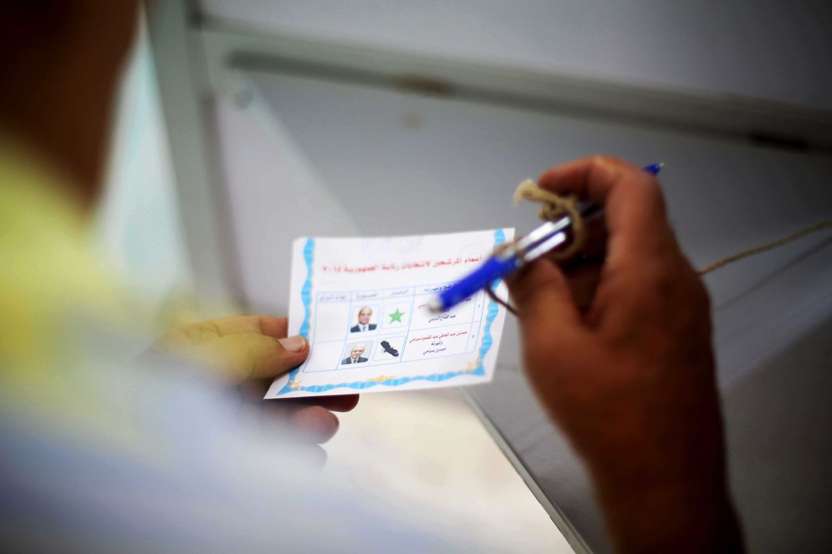 An Egyptian voter holds his ballot before voting in the presidential election in Cairo, Egypt, Monday, May 26, 2014. This weeks key vote is taking place against a backdrop of the turmoil that has roiled the country since the 2011 ouster of Hosni Mubarak and the governments crackdown against Morsis Muslim brotherhood and its allies since last July.  (AP Photo/Mostafa Elshemy) (AP)