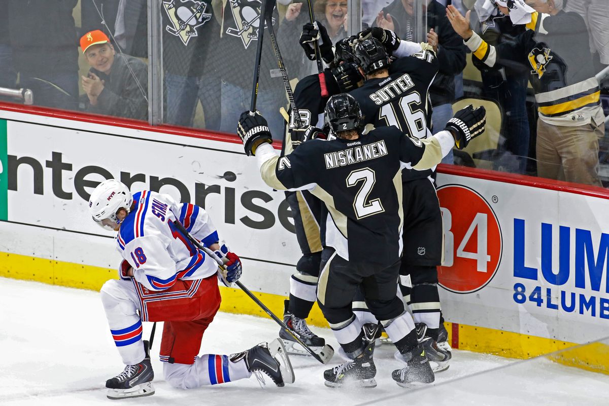 Pittsburgh Penguins' Jussi Jokinen, center not shown, celebrates his goal with teammates as New York Rangers' Marc Staal (18) kneels on the ice in the third period of game 2 of a second-round NHL playoff hockey series against the New York Rangers in Pittsburgh Sunday, May 4, 2014. The Penguins won 3-0, to tie the series at 1-1. (AP Photo/Gene J. Puskar) (AP)