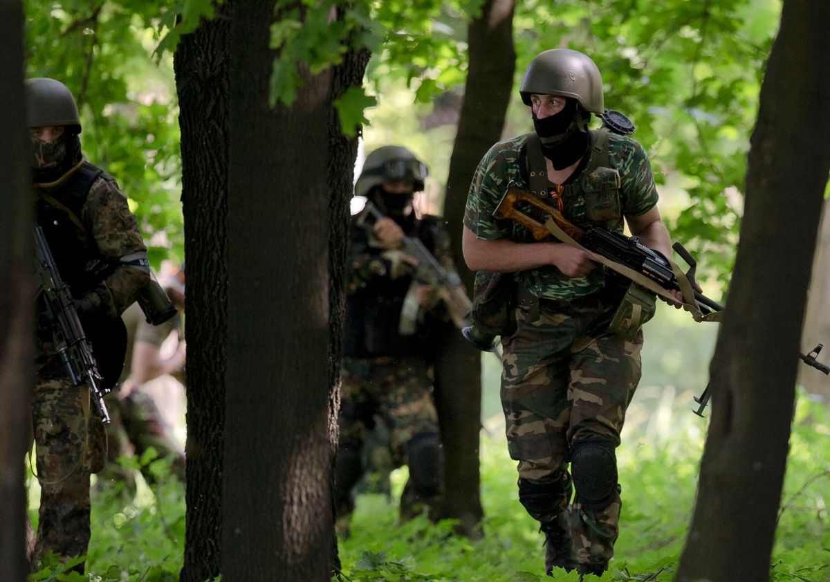 Pro-Russian gunmen take positions near the airport, outside Donetsk, Ukraine, on Monday, May 26, 2014. Ukraine's military launched air strikes Monday against separatists who had taken over the airport in the eastern capital of Donetsk in what appeared to be the most visible operation of the Ukrainian troops since they started a crackdown on insurgents last month. (AP Photo/Vadim Ghirda) (AP)