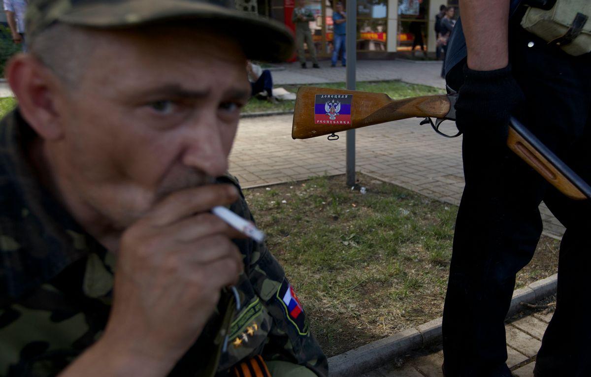 A sticker with Donetsk people's republic colors is seen on the hunting rifle of a local man who came to a check point on a road leading to the airport, in Donetsk, Ukraine, on Tuesday, May 27, 2014.  The eastern city of Donetsk was in turmoil Tuesday a day after government forces used fighter jets to stop pro-Russian militia from taking over the airport. Dozens were reported killed and the mayor went on television to urge residents to stay indoors. (AP Photo/Ivan Sekretarev) (AP)