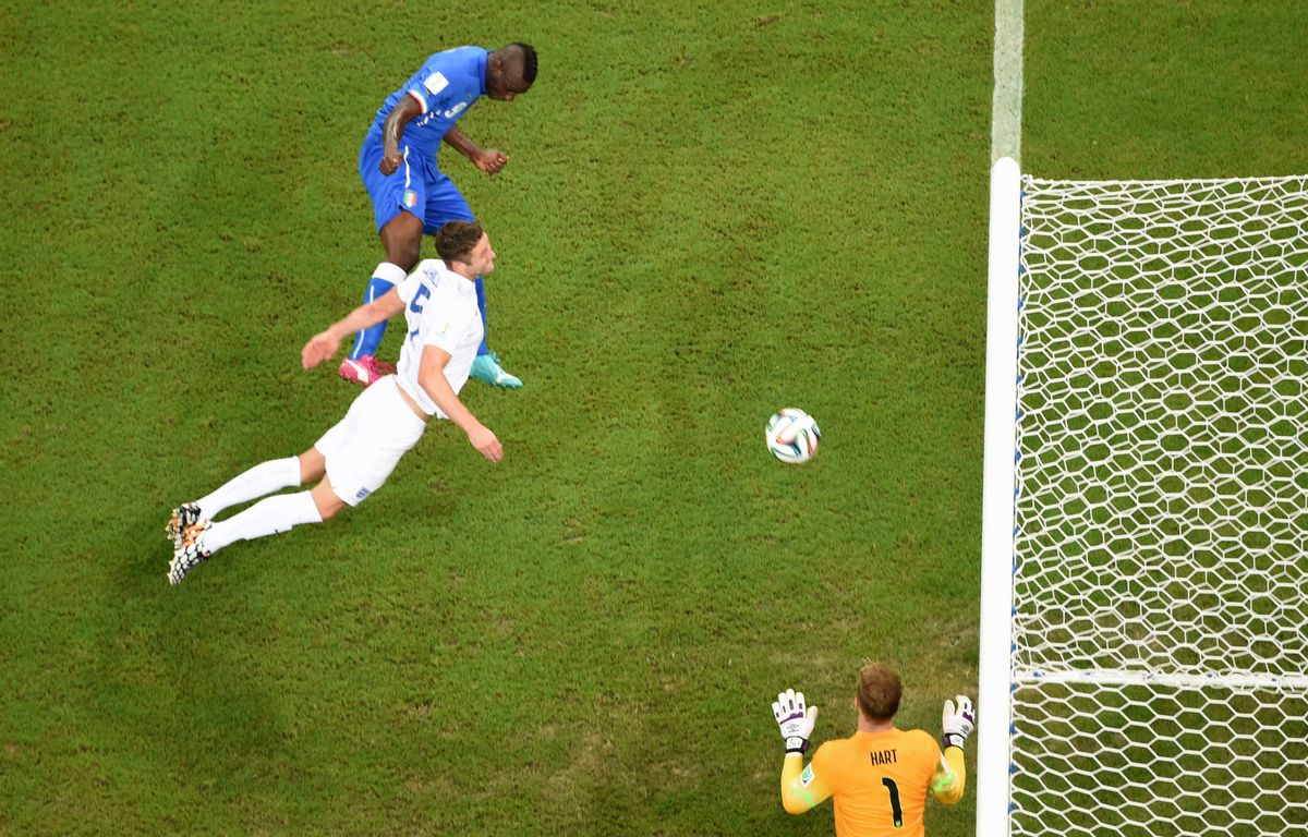 Italy's Mario Balotelli, top, scores his side's 2nd goalduring the group D World Cup soccer match between England and Italy at the Arena da Amazonia in Manaus, Brazil, Saturday, June 14, 2014.  (AP Photo/Francois Xavier Marit, pool) (Francois Xavier Marit)